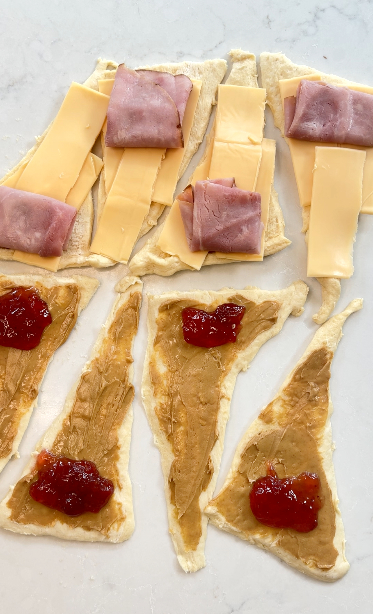 crescent roll dough filled with peanut butter and jelly; also ham and cheese.