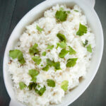 overhead serving dish with coconut lime rice and fresh cilantro.